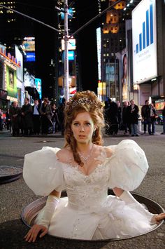 a woman in a white dress sitting on the ground