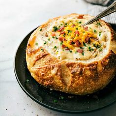 a black plate topped with bread covered in cheese