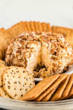 a plate with crackers and cheese ball on it