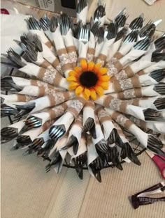 a bunch of forks are arranged in the shape of a sunflower