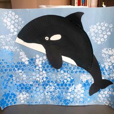 a paper bag with an orca whale on it