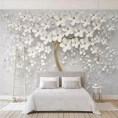 the bedroom is decorated with white flowers on the wall, and there are two tables in front of the bed