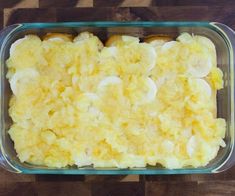 a casserole dish with bananas and other toppings in it on a wooden table