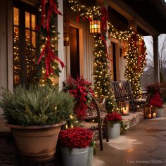 christmas decorations on the front porch of a house with lit garlands and evergreen trees