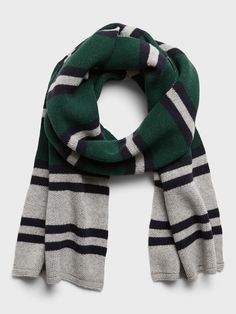 a green and white striped scarf on a gray background with black, blue, and grey stripes