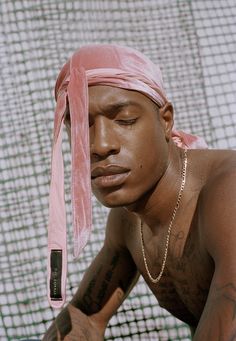 a man with a pink bandana on his head