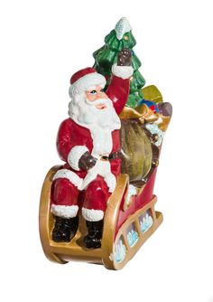 a santa clause figurine sitting on top of a sleigh