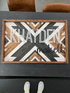 a wooden sign that says khamden made up with wood planks and white letters