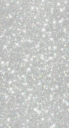 the back side of a cell phone with silver glitter on it and white stars in the background