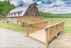 a large wooden house sitting on top of a lush green field