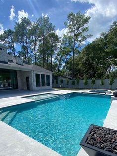 an empty swimming pool in front of a house