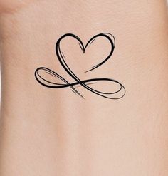 a woman's stomach with a heart tattoo on it