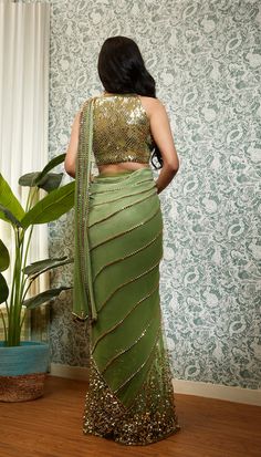 Perfect Times embodies its name, crafted from a delicate georgette base, the pre-stitched saree features net pleats, sequins, and golden beaded embroidery, which are intricately done to create a stunning texture. The saree comes with a matching halter blouse in the same shade and features delicate embroidery work, which perfectly complements the design of the saree.From Papa Don’t Preach’s Capsule collection. DELIVERY TIMEPlease allow 8-12 weeks for your outfit to arrive. FABRIC DETAILSGeorgette Embellished Saree, Green Sari, Halter Blouse, Party Attire, Tulle Sleeves, Saree Designs Party Wear, Delicate Embroidery, Korean Street, Stylish Sarees