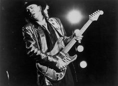 the rolling stones performing on stage with his guitar