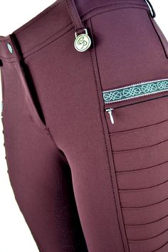 the back view of a woman's pants with zippers and pockets on it