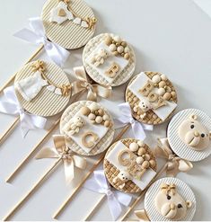 some cupcakes are arranged on sticks and decorated with fondant teddy bear decorations