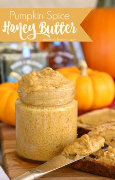 pumpkin spice honey butter in a jar next to sliced bread on a cutting board with a knife