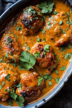 some meatballs covered in gravy and garnished with cilantro