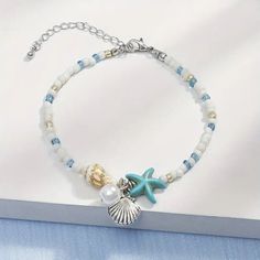 This charming bracelet features a beautiful starfish design, adding a touch of beachy elegance to any outfit. The braided chain is strong and durable, ensuring it will last for years to come. The wrap style is perfect for layering with other bracelets, creating a unique and personalized look. Crafted with high-quality materials, this bracelet is a must-have for any fashion-forward individual. Its versatile style makes it an ideal accessory for both casual and formal occasions, making it a great addition to any jewelry collection. With its unique design and durable construction, this starfish braided bracelet is sure to become a staple in your wardrobe. Beachy Bracelets, Gelang Manik-manik, Starfish Bracelet, Beach Bracelets, Starfish Pendant, Pola Gelang, Friendship Jewelry, Gelang Manik, Summer Bracelets