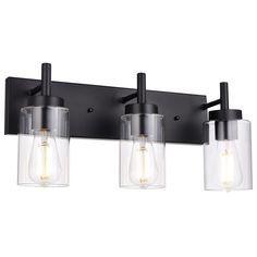 three light bathroom fixture with clear glass shades and black metal frame, on an isolated wall