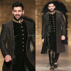 a man in a black and gold outfit walking down the runway