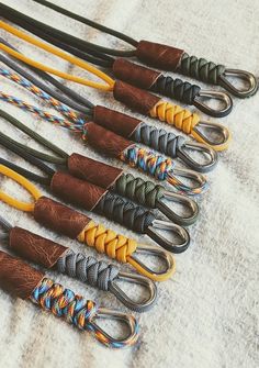 there are many different types of lanyards on the table, all lined up together