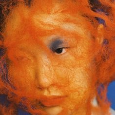 an orange haired woman with blue eyes and red hair is shown from the front view