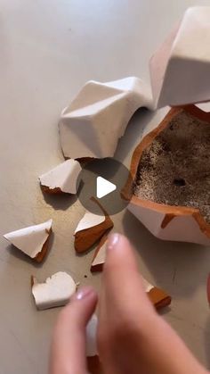 someone is peeling paper into pieces with their fingers and thumbnails on the table