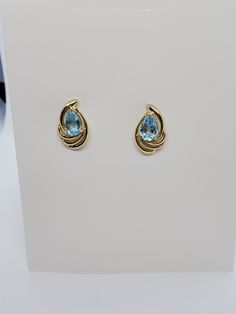 You are viewing a beautiful 14k solid gold topaz earrings. Pierced styleback. The total weight of the earrings approx.3.08 grams. Each earrings measures approx.17mm x 1mm wide. Marked 14k at the back. The earrings is in good condition. Formal Blue Topaz Diamond Earrings Fine Jewelry, Formal Blue Topaz Diamond Earrings, Yellow Gold Topaz Earrings, Round Shape, Yellow Gold Earrings With Blue Topaz Gemstone, Blue Topaz Teardrop Earrings For Anniversary, Formal Topaz Drop Earrings, Formal Topaz Earrings, Formal Yellow Gold Topaz Earrings, Gold Jewelry With Blue Topaz Stamped 14k