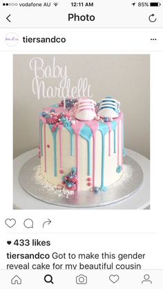 the cake is decorated with pink, blue and white icing