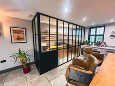 a living room filled with furniture next to a kitchen