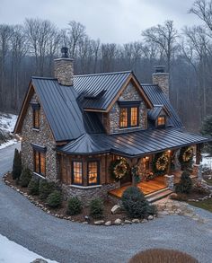 a large stone house with lights on the windows