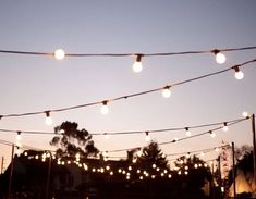 string lights are hanging from the ceiling outside