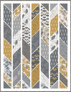 a quilt pattern with gold, grey and white colors