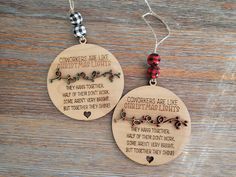 two wooden christmas ornaments with words on them