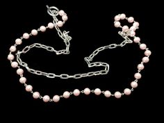 This necklace measures 40 inches long. It is a half-silver tone chain and half-pink glass faux pearls. It closes with a toggle. It looks sophisticated and classic when wearing it.It is .25 inches wide. Pink Pearl Chain Necklace For Wedding, Classic Pink Pearl Chain Jewelry, Adjustable Pink Pearl Chain Necklace, Heart-shaped Pink Pearl Necklace, Pink Baroque Pearl Single Strand Necklace, Rhinestone Watches, Pewter Pendant, Hippie Necklace, Cross Bracelet