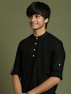 YUVA By VASTRAMAY Boys Black Short Kurta This black, short kurta features a mandarin collar, full sleeves with roll-up option, button placket, and a curved hem. Made from a comfortable cotton blend, it's perfect for everyday wear or special occasions. Key Features Black color Mandarin collar Full sleeves with roll-up option Button placket Curved hem Specifications Top Fabric: Cotton Blend Material & Care Dry clean only Legal Disclaimer: The product is guaranteed to be 100% genuine. Product image Black Shirt With Button Closure And Stand Collar, Black Shirt With Stand Collar And Buttons, Black Stand Collar Shirt, Black Traditional Kurta With Stand Collar, Traditional Black Tops With Buttons, Short Kurta, Boys Wear, Full Sleeves, Packaging Labels