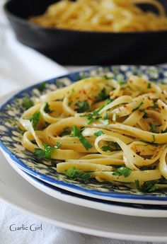 pasta with parsley on a blue and white plate