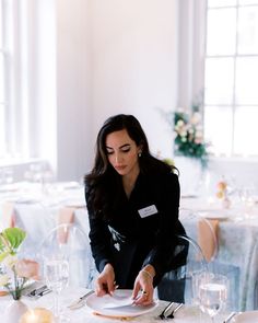 a woman sitting at a table with a plate in front of her