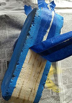 a blue and white toothbrush sitting on top of a newspaper