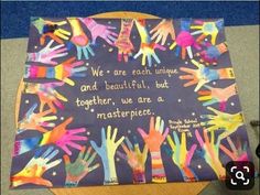 children's handprints on a bulletin board that says we are each unique and beautiful but together, we are a masterpiece