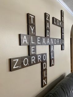 a cross made out of scrabble tiles on the wall