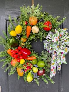 a wreath with fruits and vegetables hanging on the front door to welcome people into the house