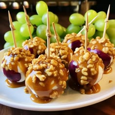 caramel apples with walnuts and grapes on a plate