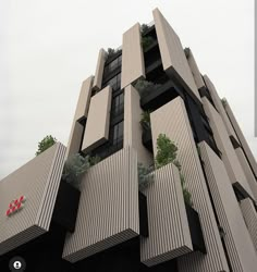 a very tall building with some plants growing on it