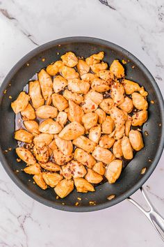 chicken is cooking in a skillet on the counter