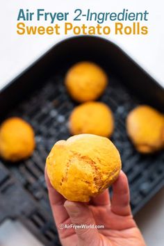 a hand holding up a potato that is on top of a grill with the words air fryer 2 ingredient sweet potato rolls