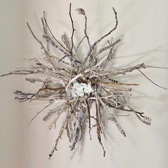 a clock made out of branches on the wall