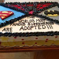 a birthday cake that is decorated with different types of supermans and the words, the world's most famous superheros are adopted