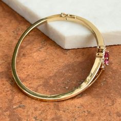 Vintage 14KT Yellow Gold Designer AJ Bangle Bracelet with Large Oval Pink Tourmaline Gemstone and Halo Prong Set Diamonds. Estate Vintage Uniquely Crafted Well Made Piece Hinged w/ safety latch, very secure Weight: 15.70 Grams Diamonds: approx 1.05 CT TW VS/ H Color 8mm x 6mm Pink Tourmaline approx 1.40+ carat Measures: 60 mm in diameter 14.5 mm wide front 2mm back Marked 14KT AJ Diamond Bangles Bracelet, White Gold Bracelet, White Gold Necklaces, White Gold Earrings, Diamond Bangle, Yellow Gold Bracelet, Yellow Gold Pendants, Yellow Gold Earring, Tourmaline Gemstone